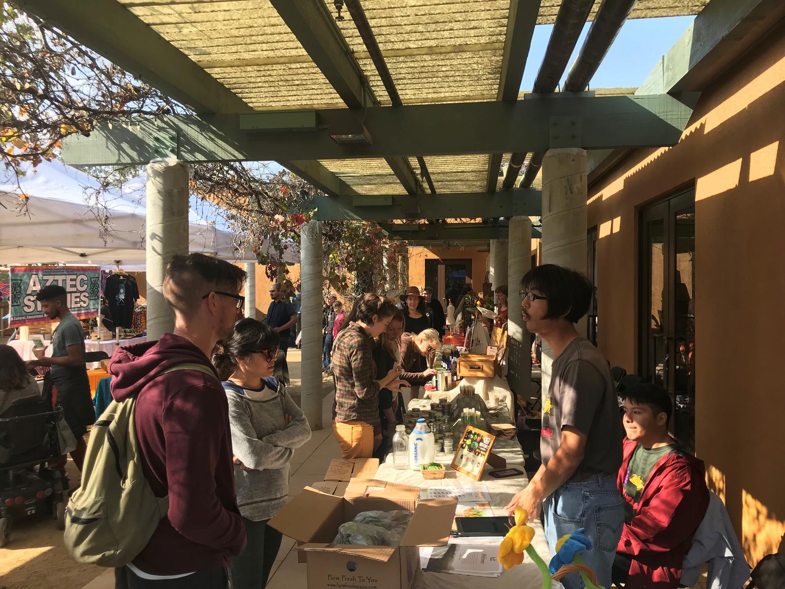 Visitors check out vendor stands at the Arroyo Seco Marketplace