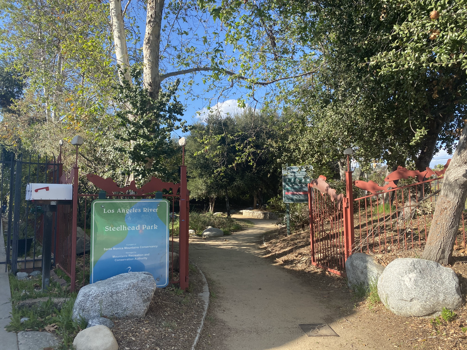 Photo of LA River park sign (Steelhead Park) and park entryway 