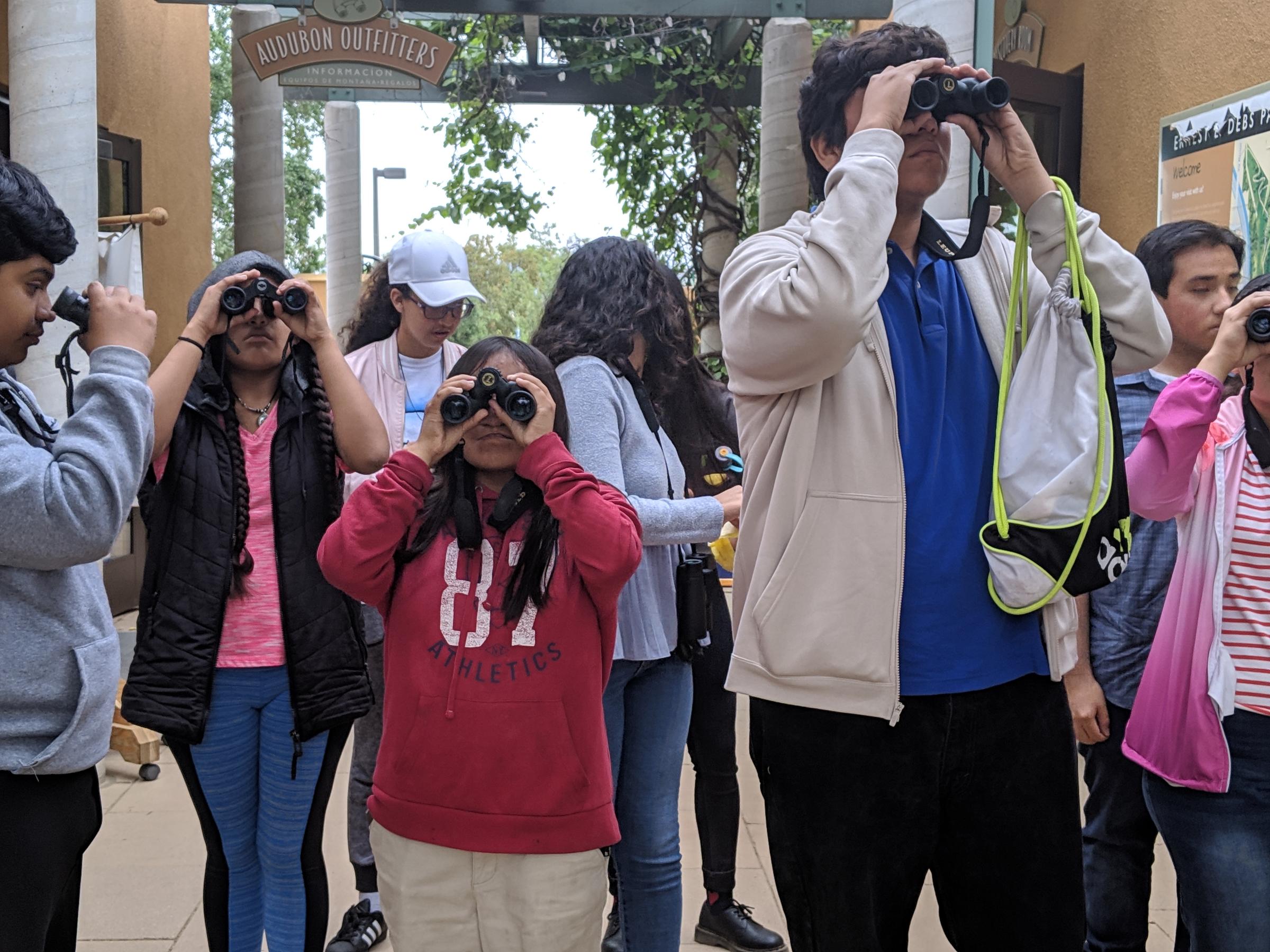 Students look through binoculars during the Center's Bioblitz.